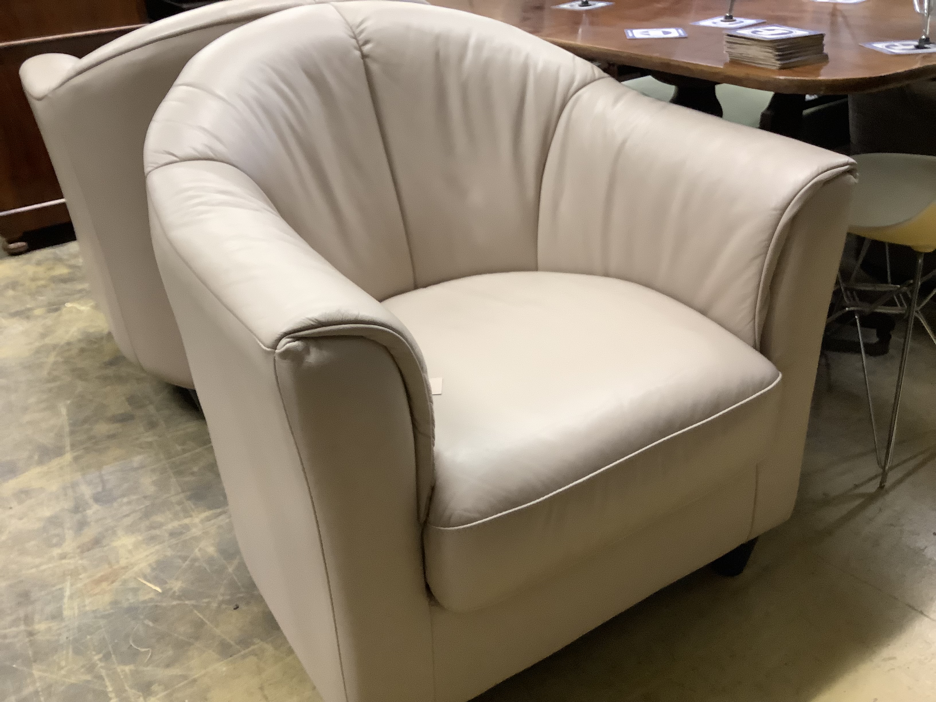 A pair of contemporary tub chairs upholstered in taupe hide, width 74cm, depth 76cm, height 80cm